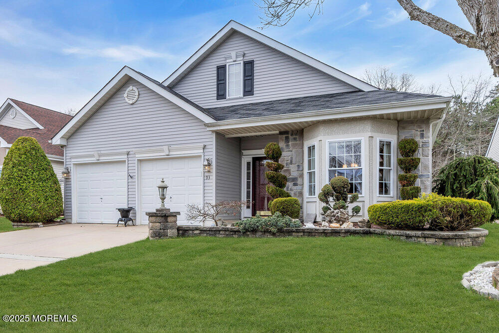 a front view of a house with a yard and outdoor seating