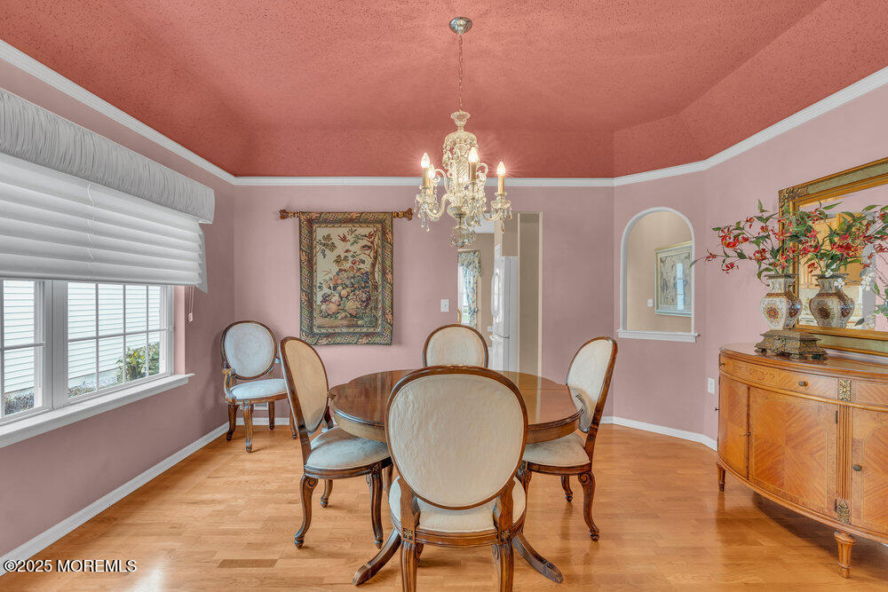 93 Pebble Beach Boulevard Jackson, NJ 08527 - Photo 12 of 47 a dining room with furniture a chandelier and wooden floor