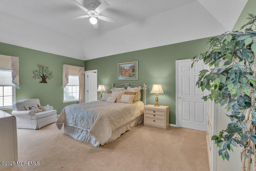 93 Pebble Beach Boulevard Jackson, NJ 08527 - Photo 15 of 47 a bedroom with a bed and a potted plant