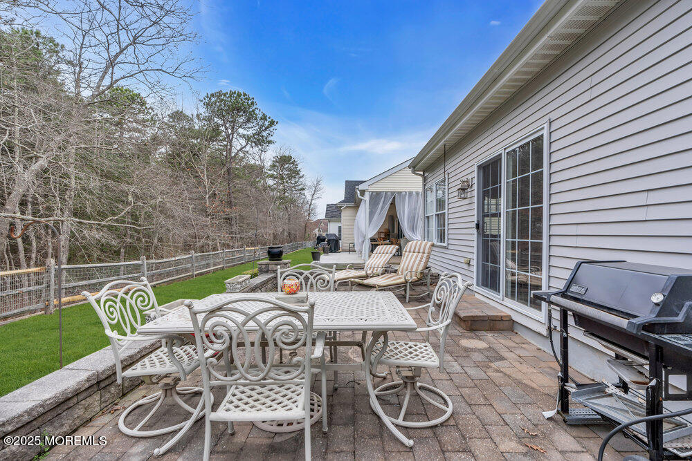 93 Pebble Beach Boulevard Jackson, NJ 08527 - Photo 25 of 47 a view of a patio with a dining table and chairs with wooden floor