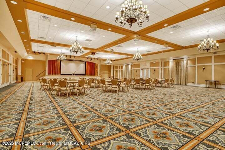 93 Pebble Beach Boulevard Jackson, NJ 08527 - Photo 37 of 47 a room with lots of chairs and chandelier