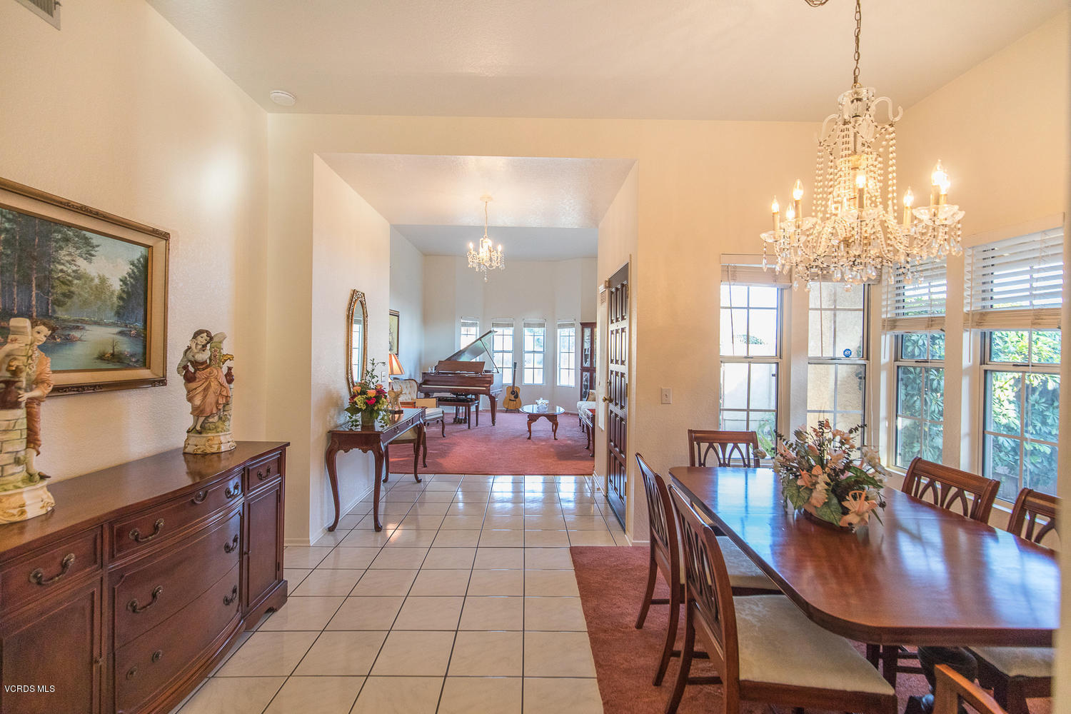 2073 Old Ranch Road Camarillo, CA 93012 - Photo 20 of 47 a view of a dining room with furniture a chandelier and large windows