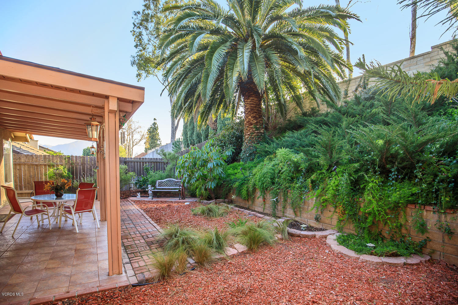 2073 Old Ranch Road Camarillo, CA 93012 - Photo 8 of 47 a view of a patio with a table and chairs under an umbrella
