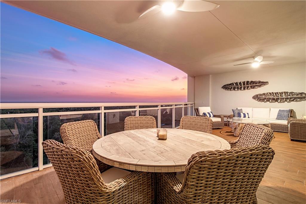 a dining room with furniture and a floor to ceiling window