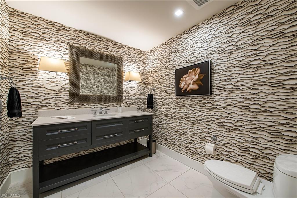 13915 Old Coast Road, Unit 602 Naples, FL 34110 - Photo 14 of 25 a bathroom with a sink and a mirror