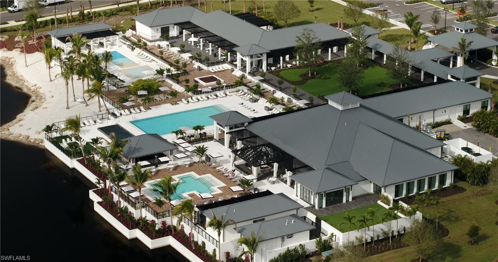 13915 Old Coast Road, Unit 602 Naples, FL 34110 - Photo 23 of 25 an aerial view of multiple houses with yard