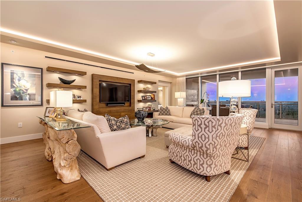 13915 Old Coast Road, Unit 602 Naples, FL 34110 - Photo 3 of 25 a living room with furniture and a fireplace