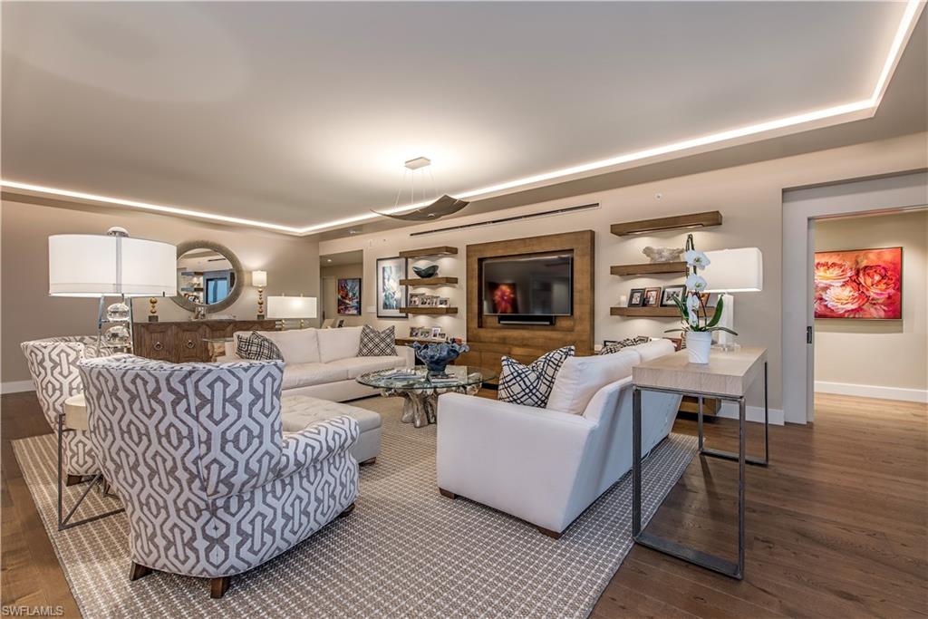 13915 Old Coast Road, Unit 602 Naples, FL 34110 - Photo 4 of 25 a living room with furniture and a flat screen tv