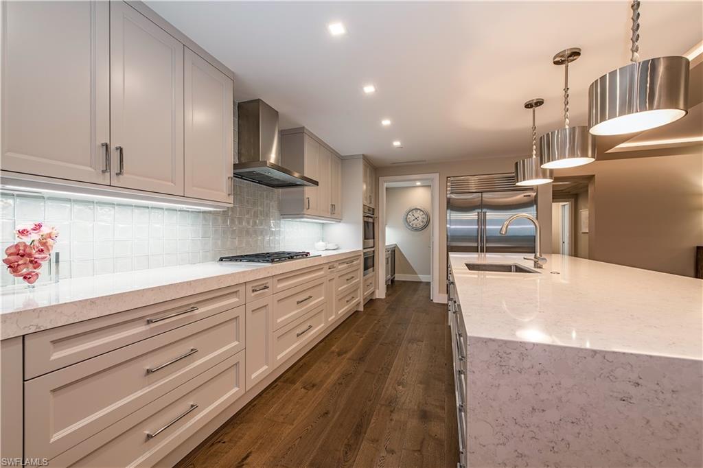 13915 Old Coast Road, Unit 602 Naples, FL 34110 - Photo 7 of 25 a large kitchen with cabinets