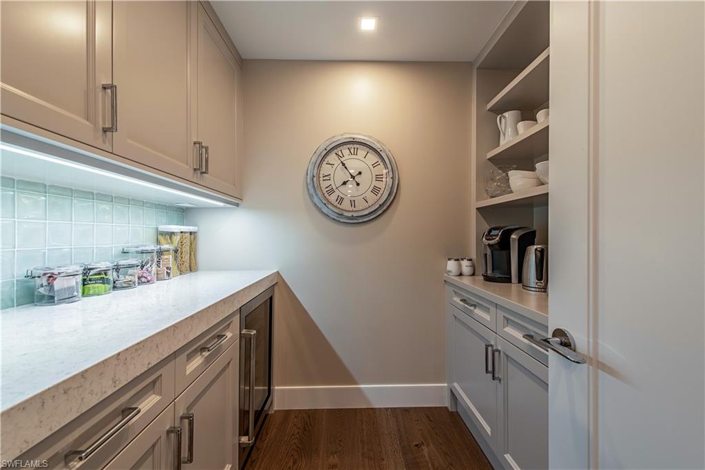 13915 Old Coast Road, Unit 602 Naples, FL 34110 - Photo 8 of 25 a view of storage and utility room with racks on the wall