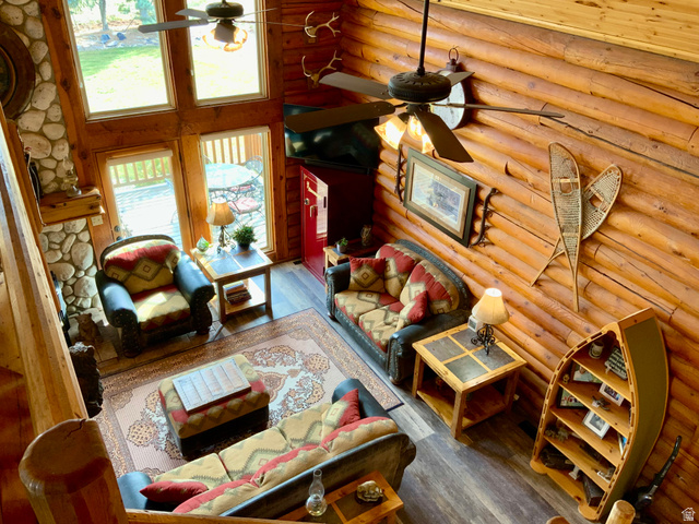 76 Highway 118 Monroe, UT 84754 - Photo 48 of 76 Living room with wood finished floors, a towering ceiling, and log walls