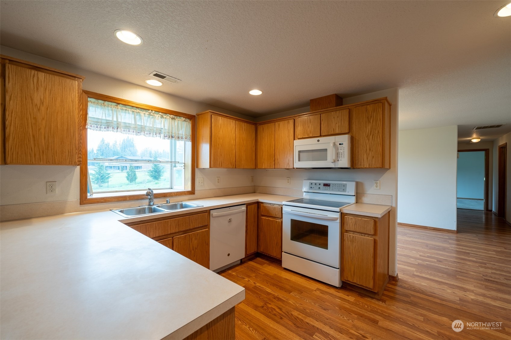 444 Bond Road Castle Rock, WA 98611 - Photo 12 of 40 a kitchen with stainless steel appliances granite countertop wooden cabinets a sink and a stove