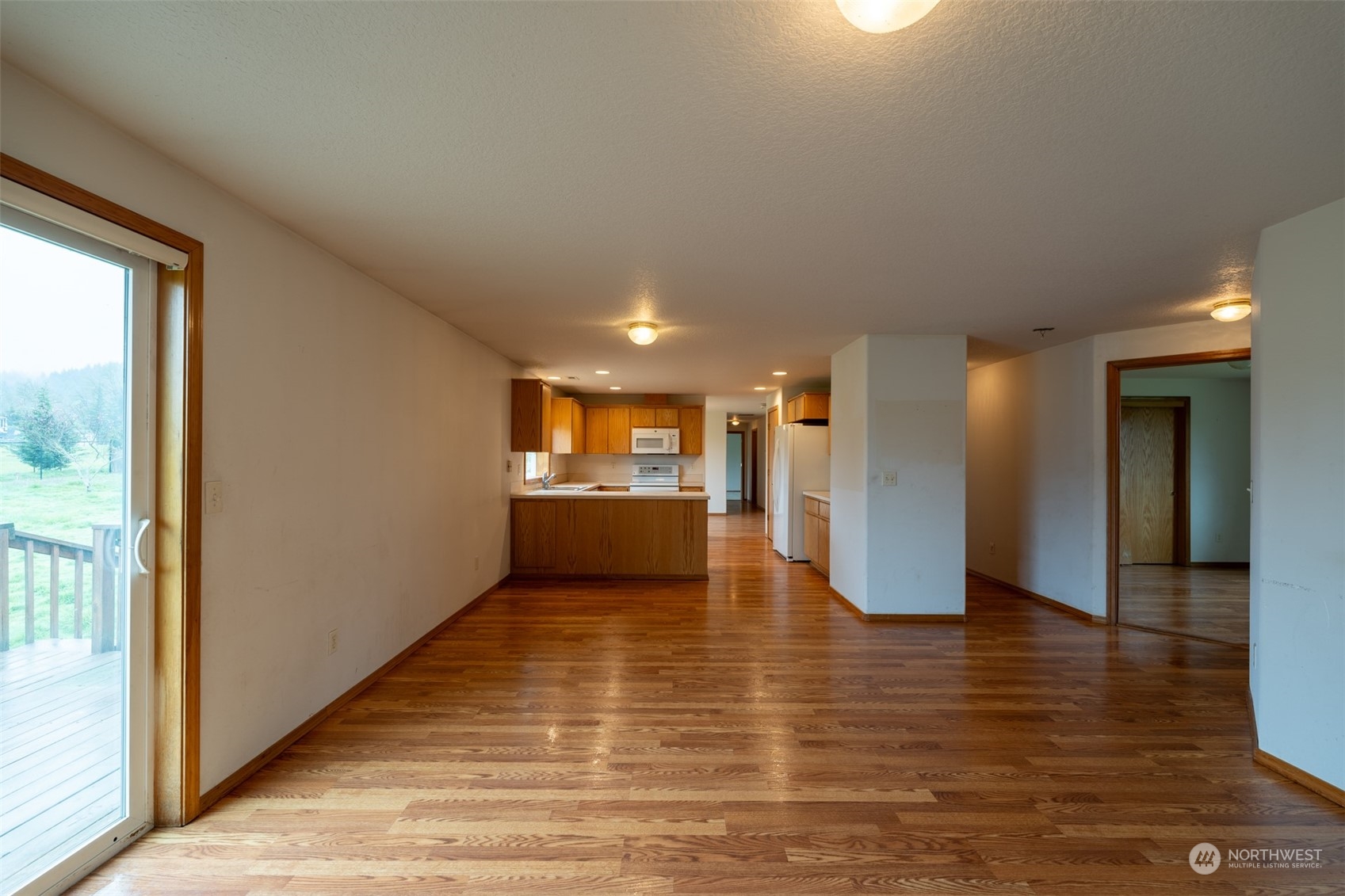 444 Bond Road Castle Rock, WA 98611 - Photo 14 of 40 a view of a hallway with wooden floor and a kitchen