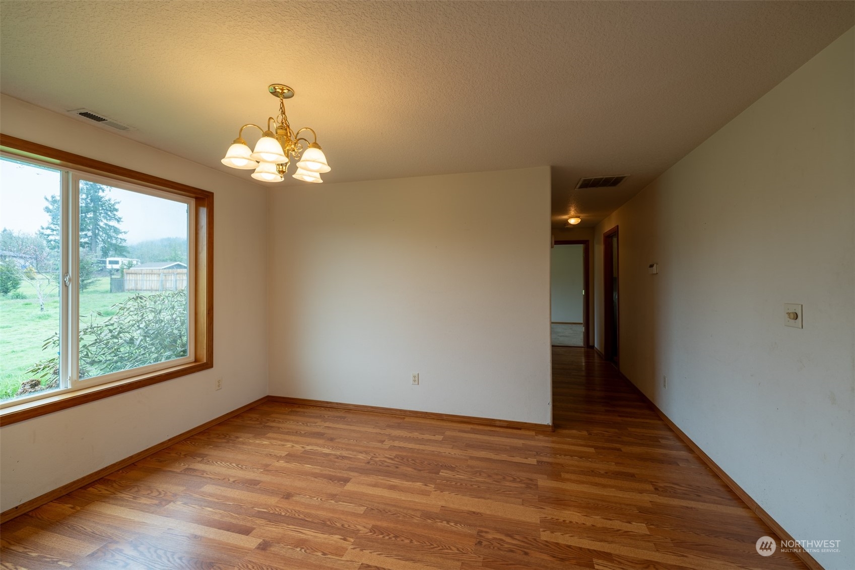 444 Bond Road Castle Rock, WA 98611 - Photo 21 of 40 wooden floor in an empty room with a window