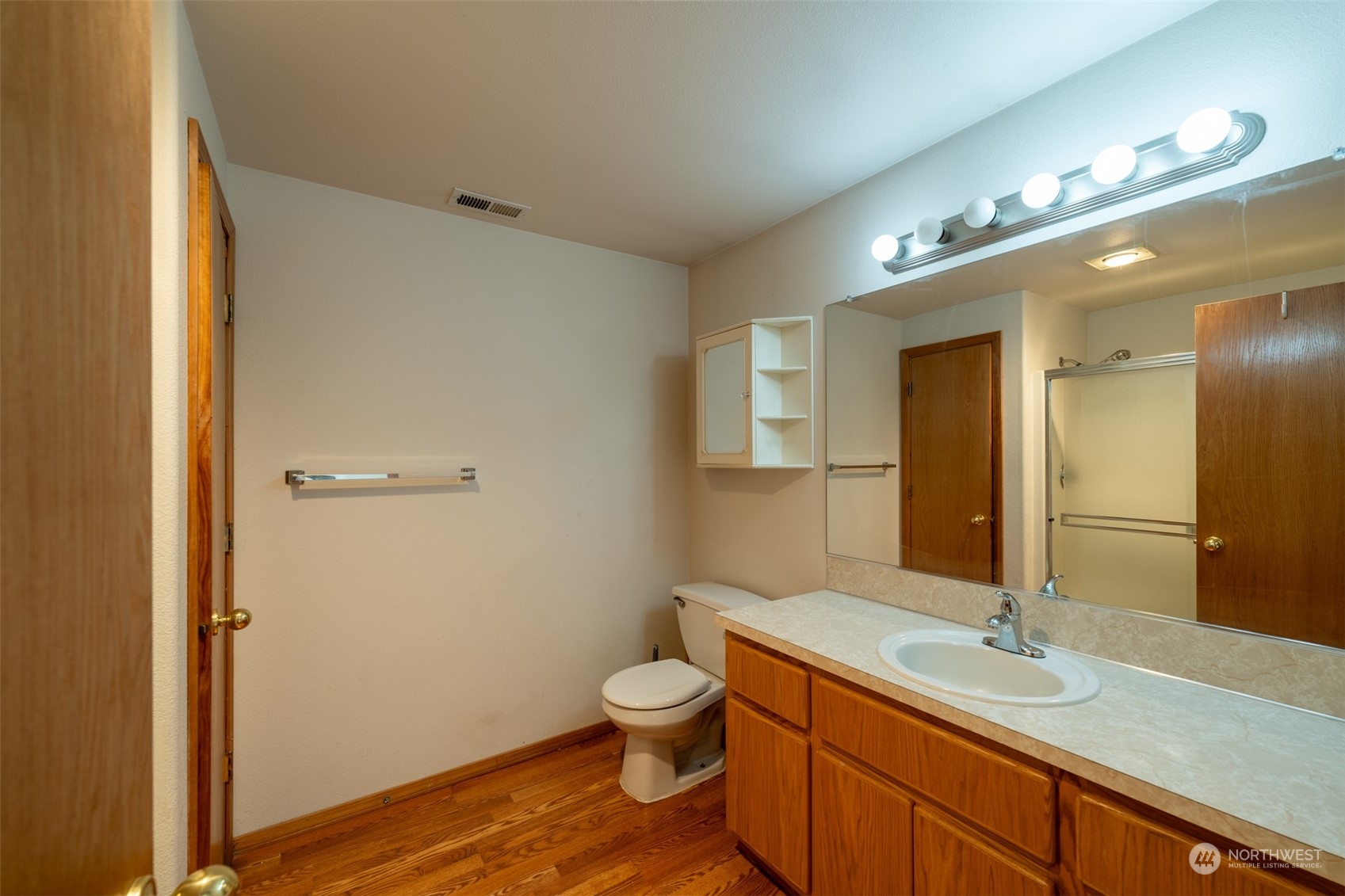 444 Bond Road Castle Rock, WA 98611 - Photo 25 of 40 a bathroom with a granite countertop sink toilet and mirror