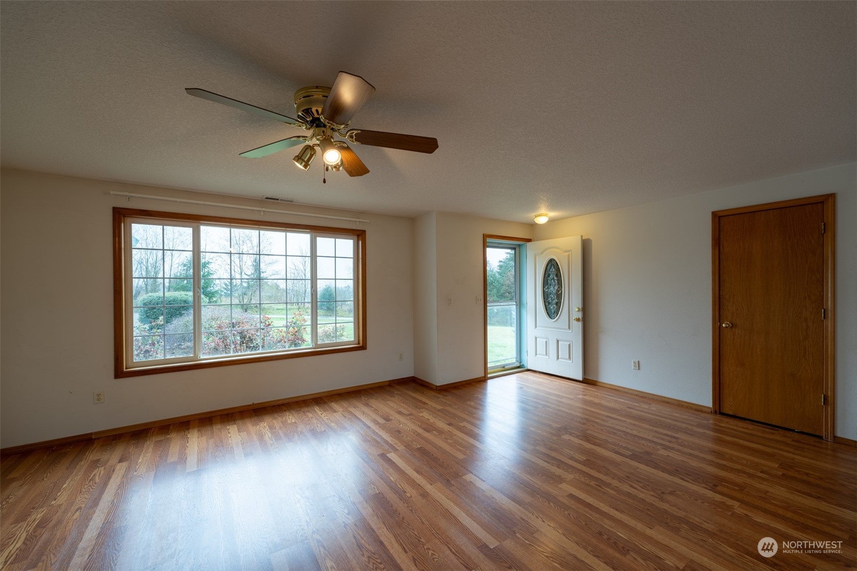 444 Bond Road Castle Rock, WA 98611 - Photo 4 of 40 a view of an empty room with wooden floor and a window