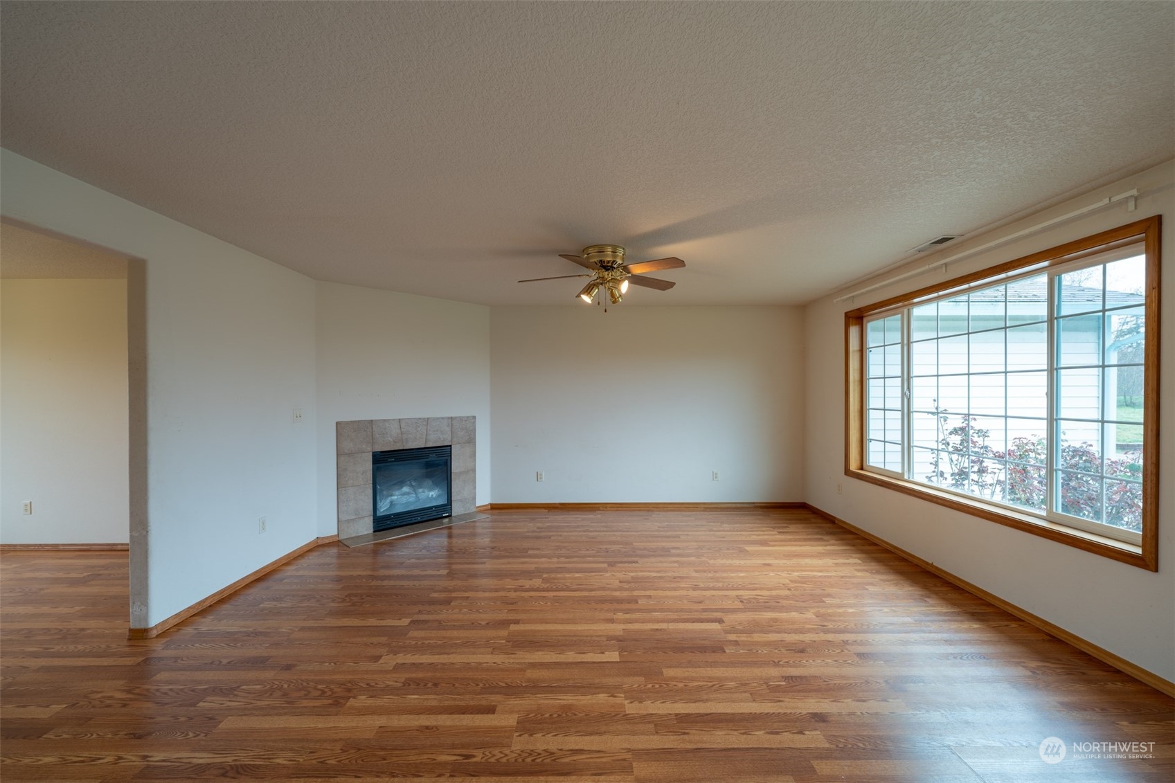 444 Bond Road Castle Rock, WA 98611 - Photo 5 of 40 wooden floor fireplace and windows in an empty room