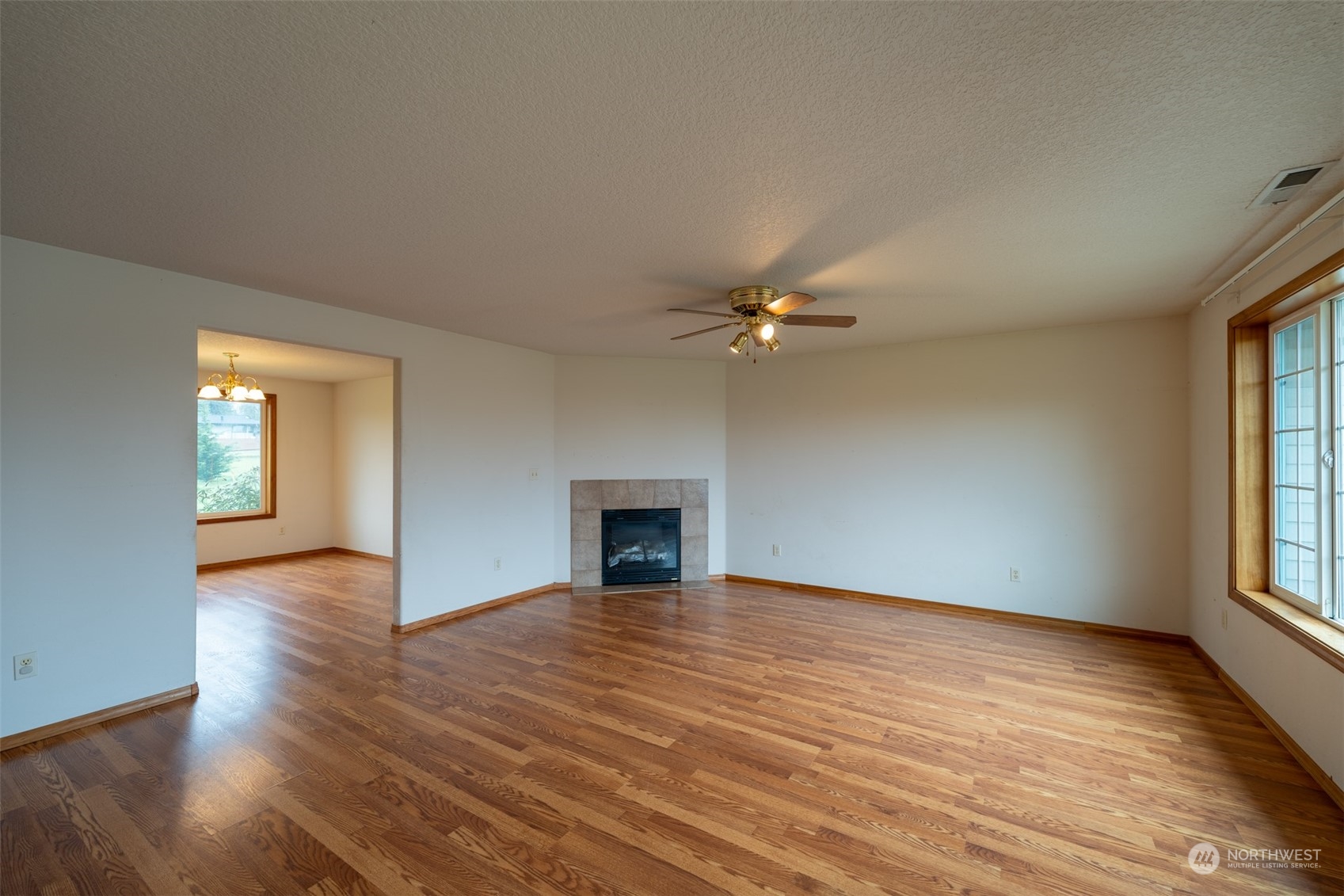444 Bond Road Castle Rock, WA 98611 - Photo 6 of 40 a view of empty room with wooden floor and fan
