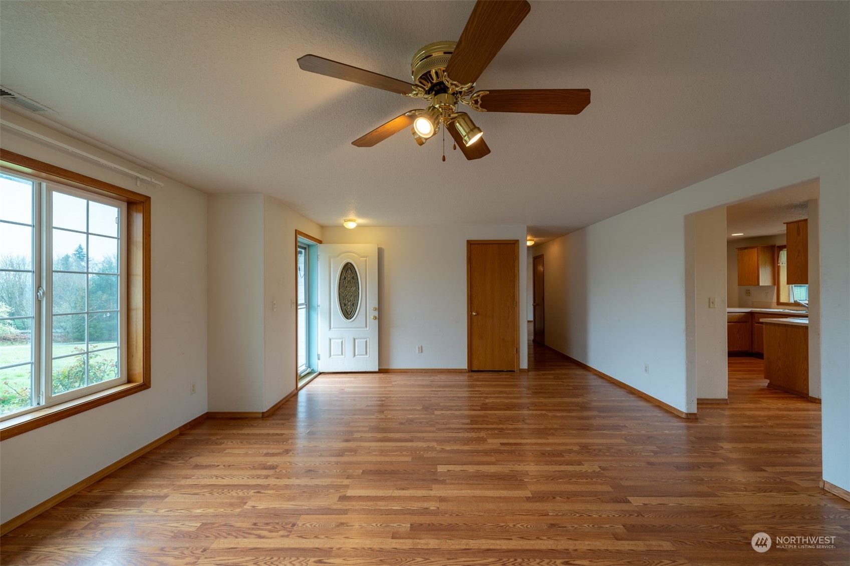 444 Bond Road Castle Rock, WA 98611 - Photo 7 of 40 a view of an empty room with window and wooden floor