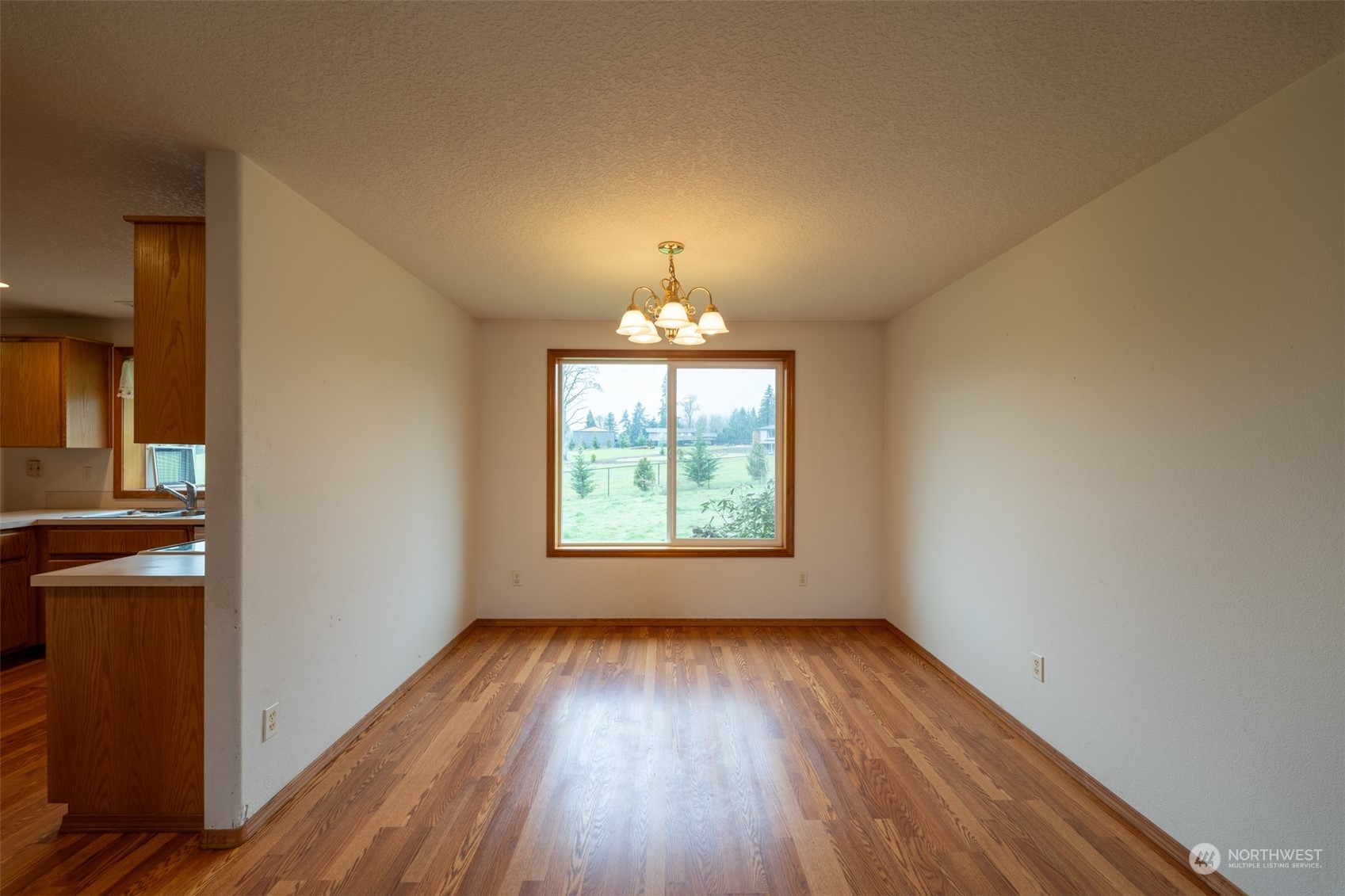 444 Bond Road Castle Rock, WA 98611 - Photo 8 of 40 a view of an empty room with wooden floor and a window
