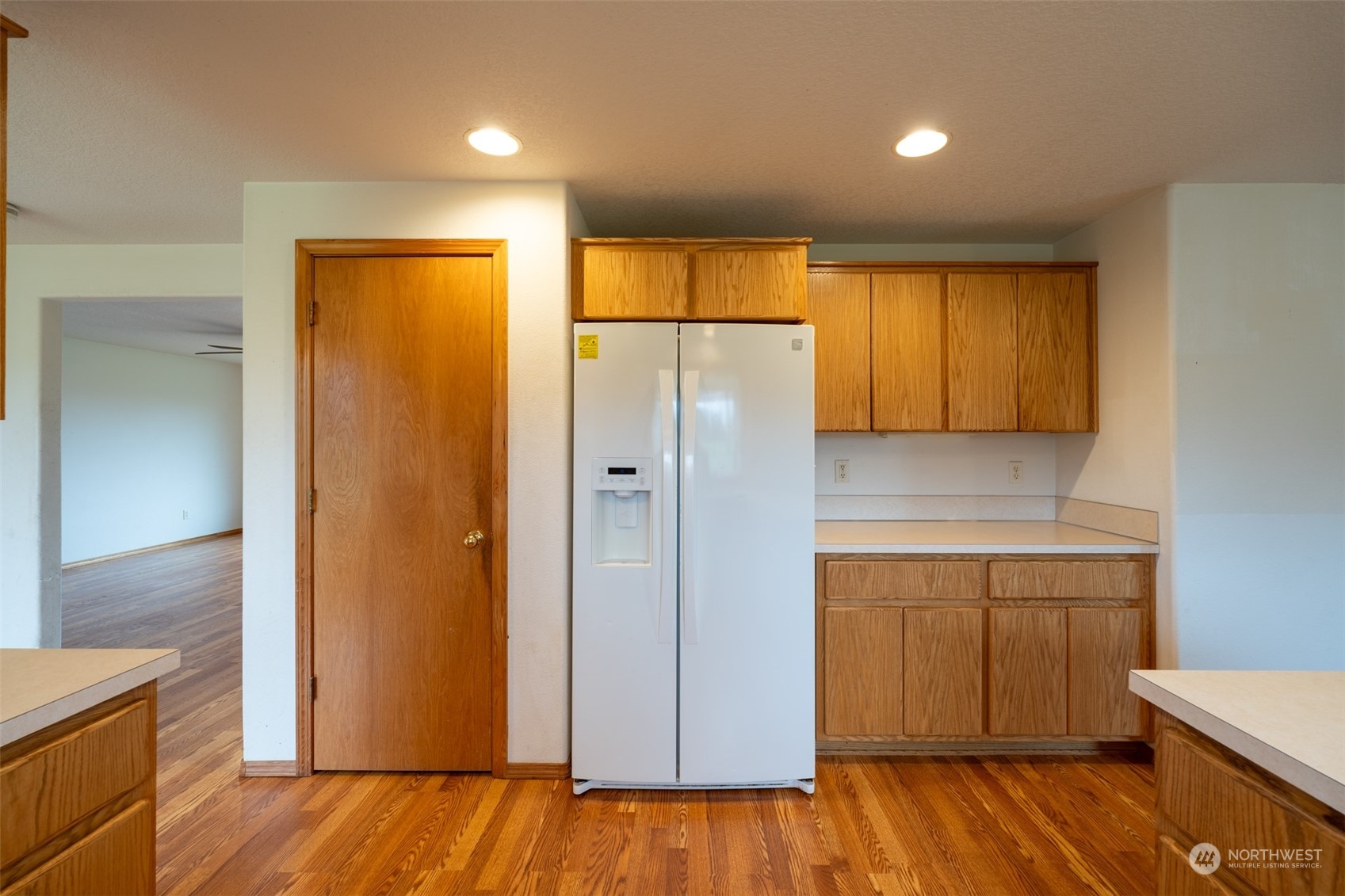 444 Bond Road Castle Rock, WA 98611 - Photo 10 of 40 a view of a refrigerator in kitchen and wooden floor