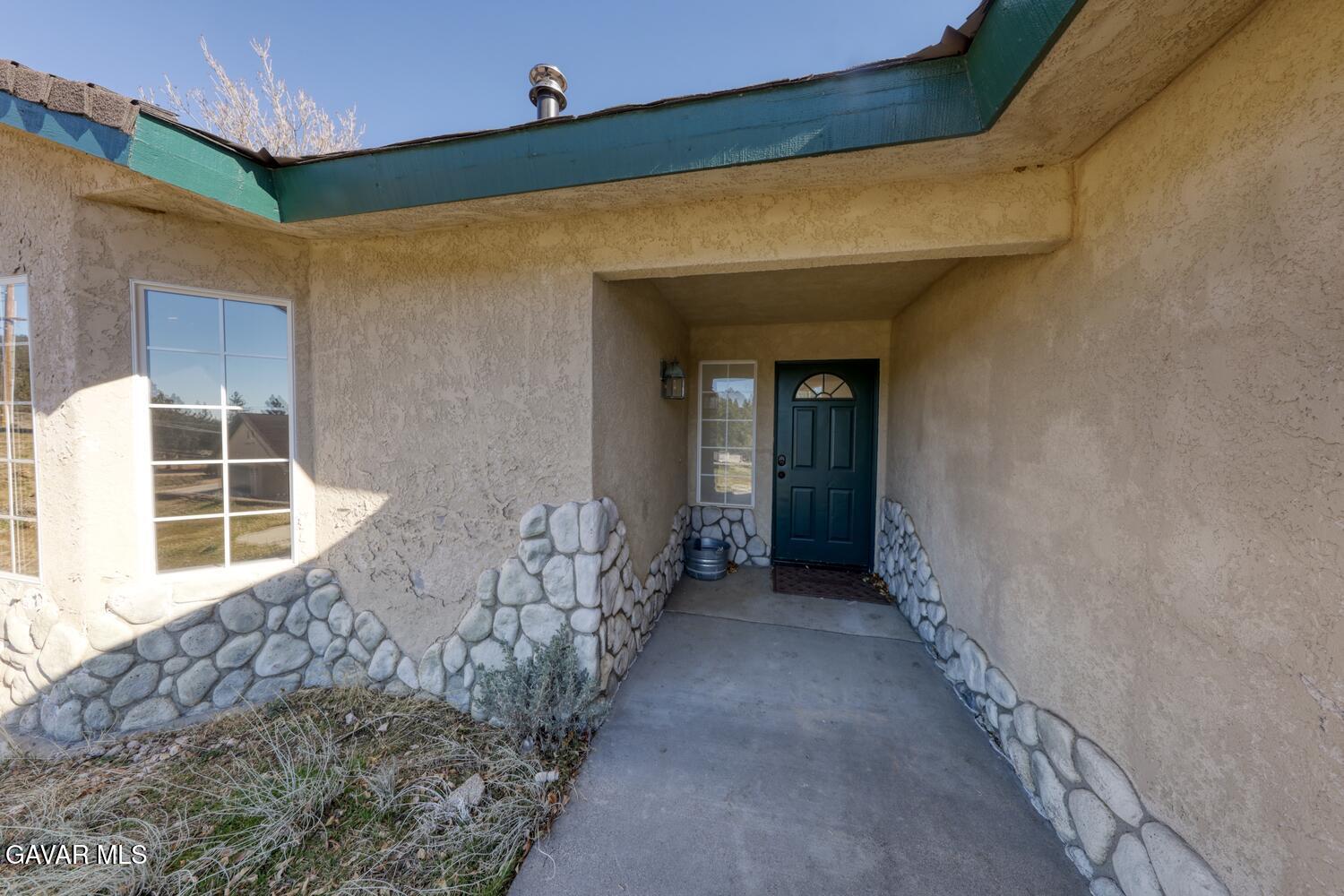 26801 Cabriolet Court Tehachapi, CA 93561 - Photo 5 of 60 a view of a house with a wooden door