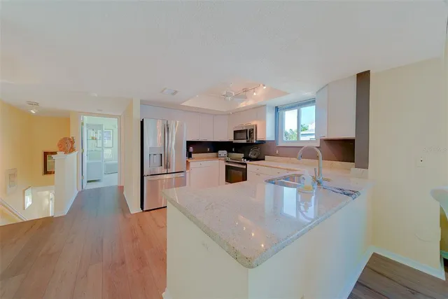 a kitchen with stainless steel appliances granite countertop a sink and cabinets