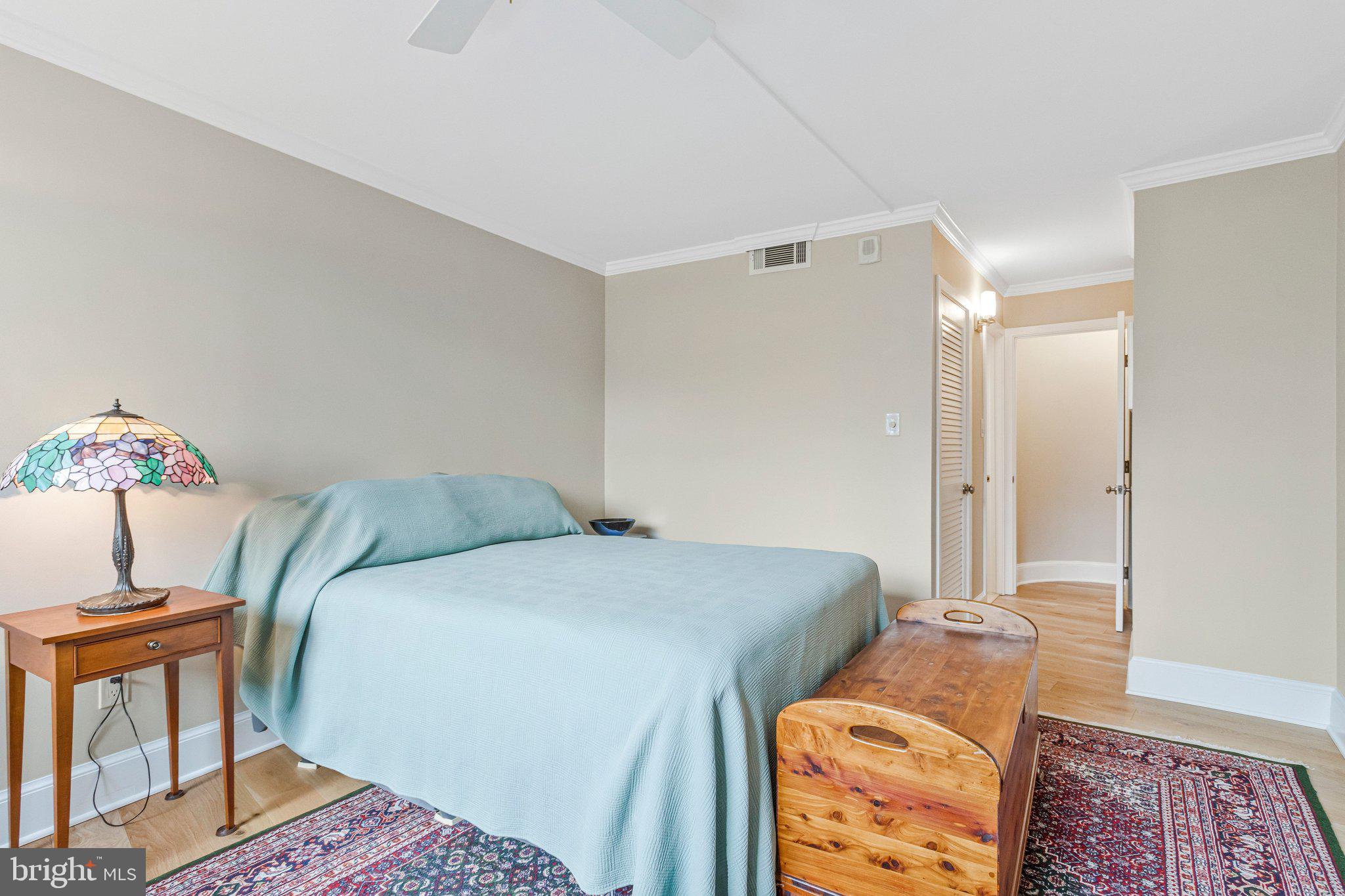 1101 South Arlington Ridge Road, Unit 706 Arlington, VA 22202 - Photo 37 of 59 a bedroom with a bed and wooden floor