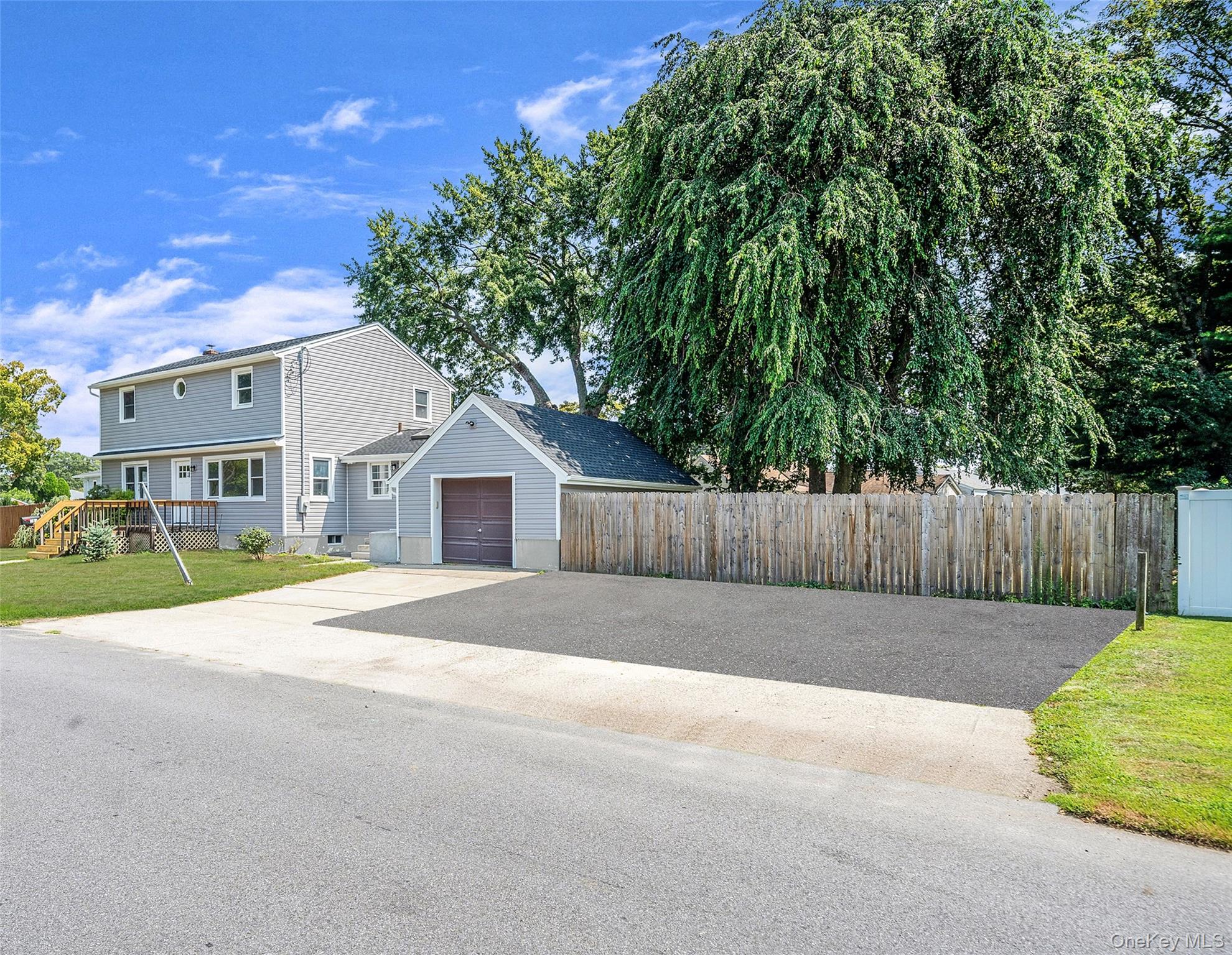 286 Old Country Road Deer Park, NY 11729 - Photo 1 of 33 a front view of a house with a yard and garage