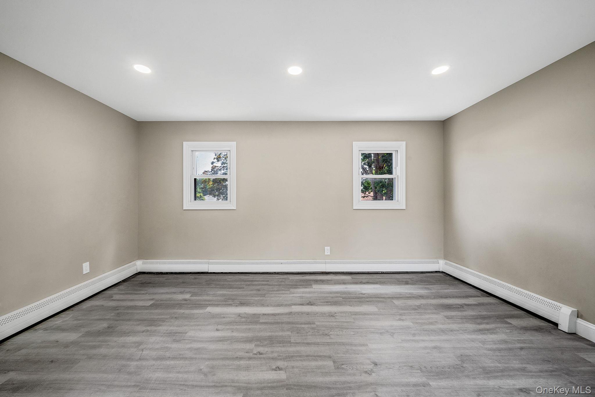 286 Old Country Road Deer Park, NY 11729 - Photo 14 of 33 a view of empty room with wooden floor and fan