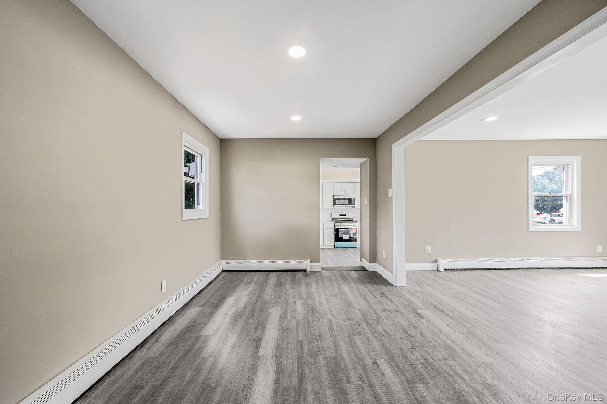 286 Old Country Road Deer Park, NY 11729 - Photo 16 of 33 an empty room with wooden floor and windows
