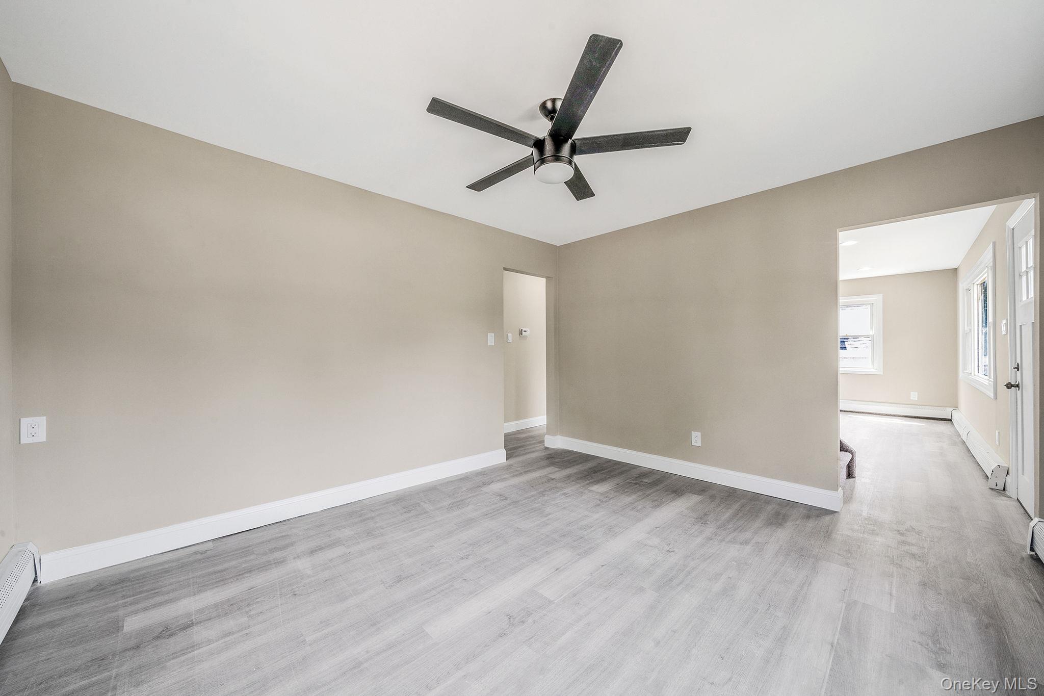 286 Old Country Road Deer Park, NY 11729 - Photo 19 of 33 an empty room with wooden floor and windows