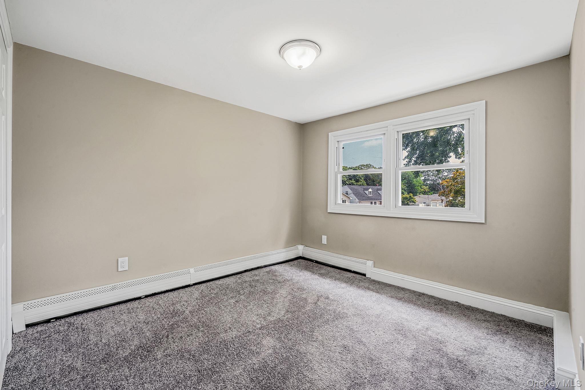 286 Old Country Road Deer Park, NY 11729 - Photo 26 of 33 an empty room with windows