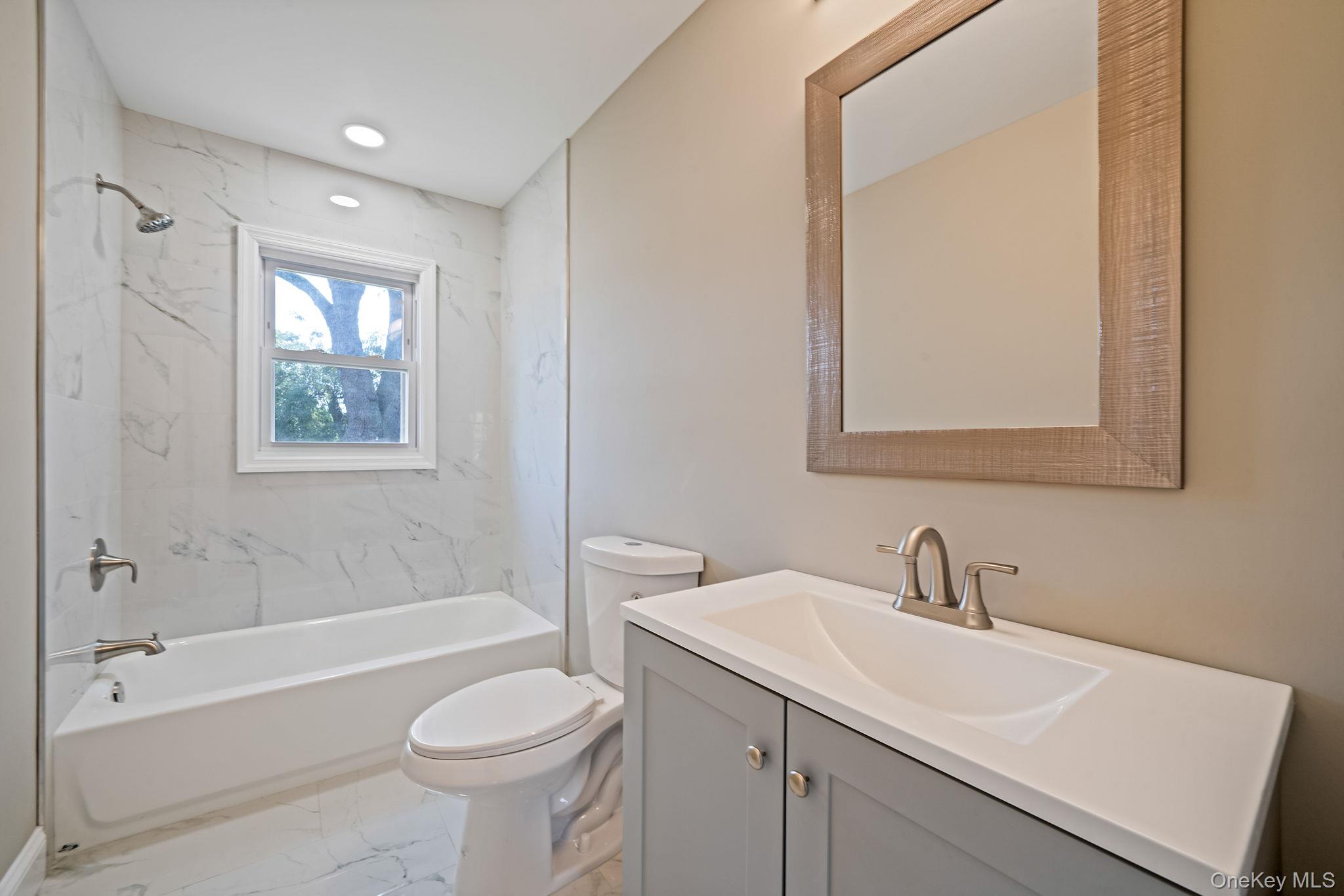 286 Old Country Road Deer Park, NY 11729 - Photo 28 of 33 a bathroom with a sink toilet and bathtub
