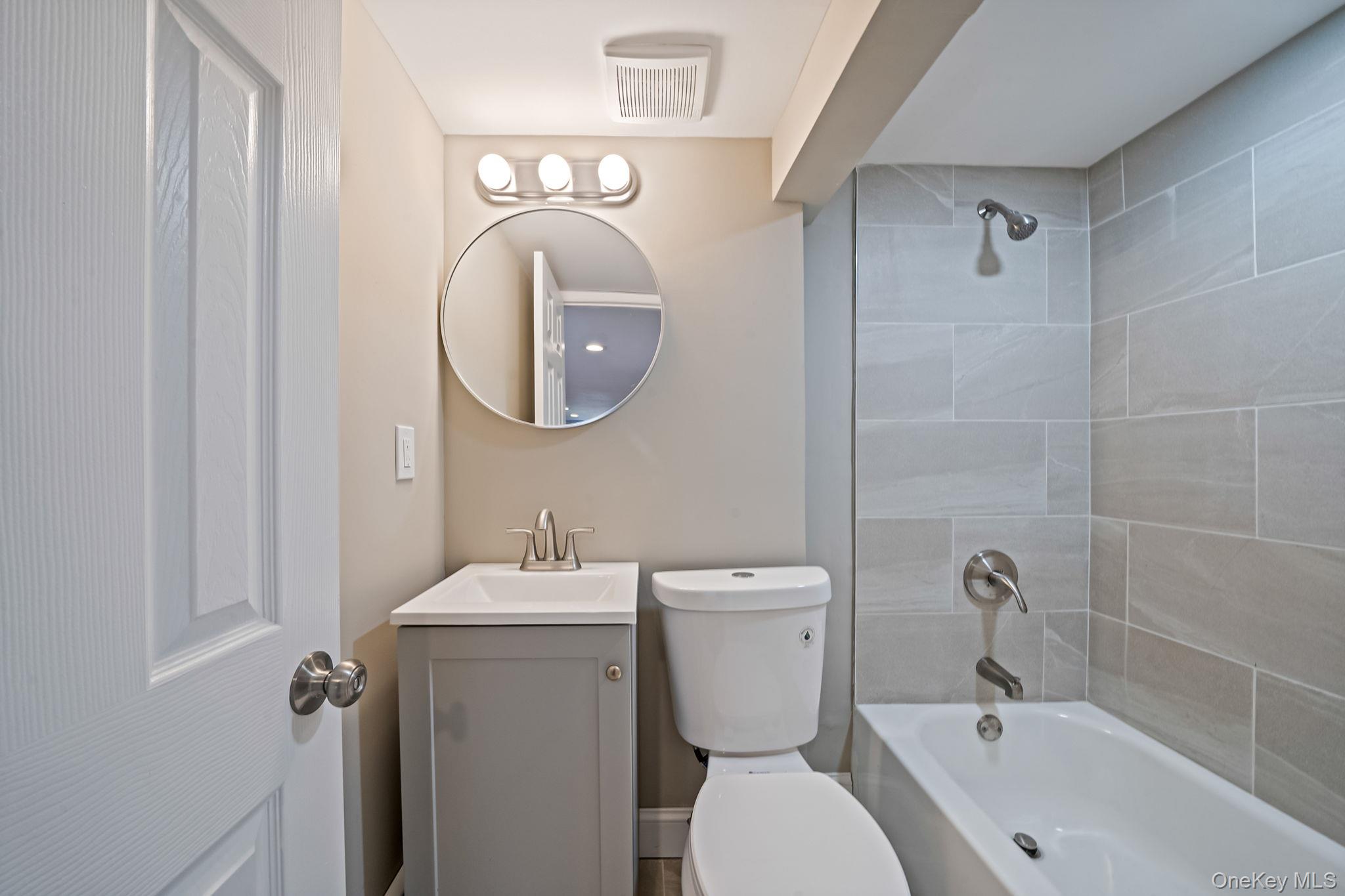 286 Old Country Road Deer Park, NY 11729 - Photo 31 of 33 a bathroom with a toilet sink and mirror