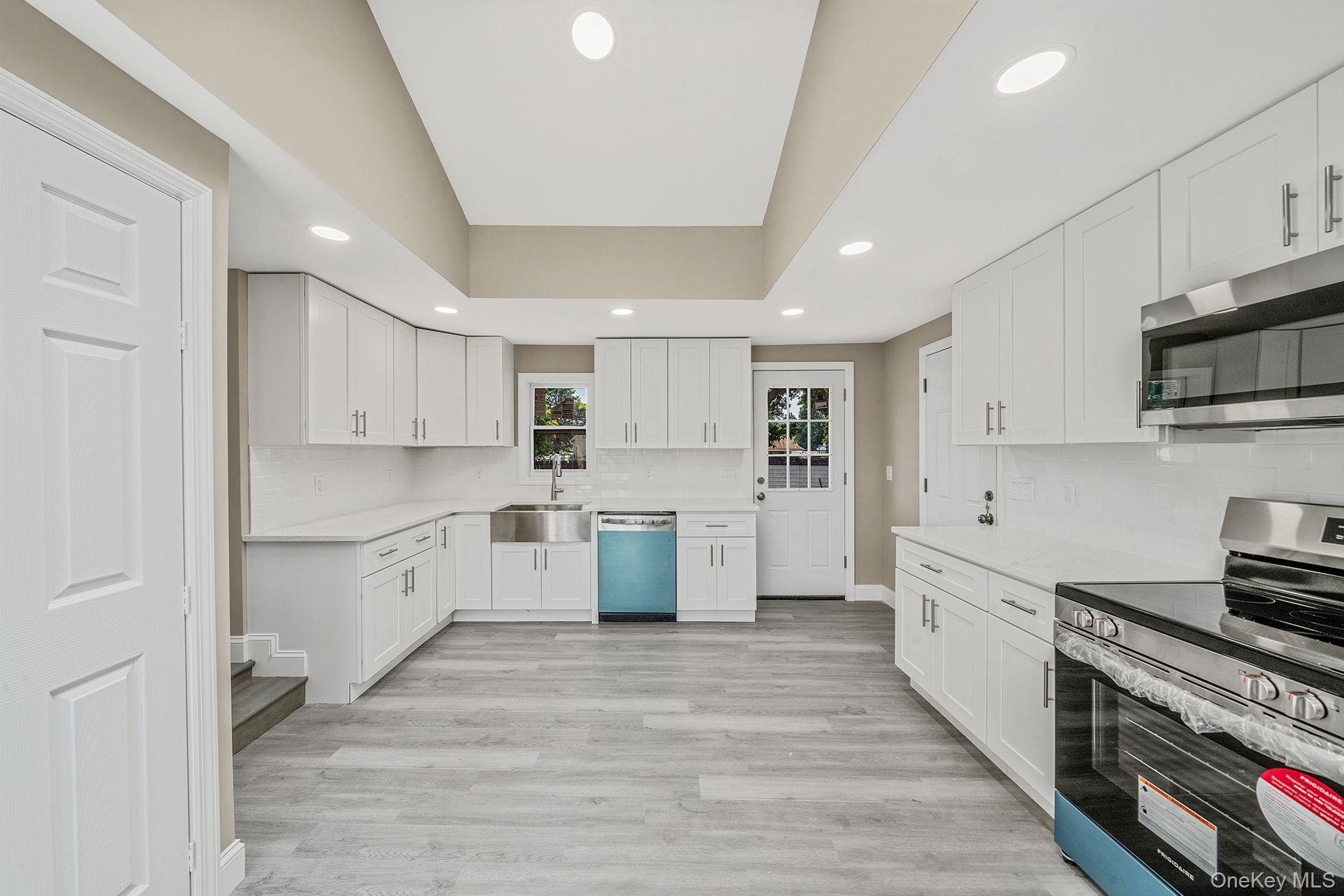 286 Old Country Road Deer Park, NY 11729 - Photo 10 of 33 a kitchen with white cabinets and appliances