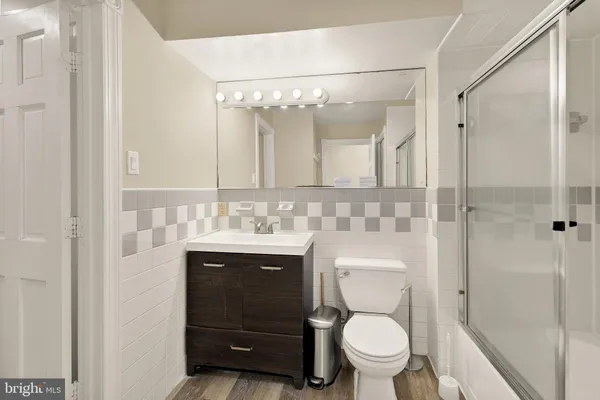 a bathroom with a toilet a sink and mirror