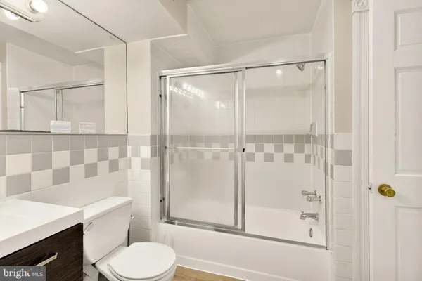 a bathroom with a shower toilet and sink