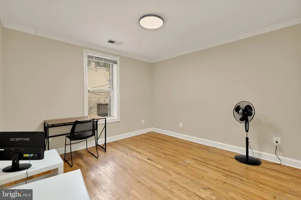 a view of an empty room and wooden floor