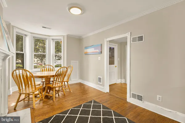 a dining room with furniture and window