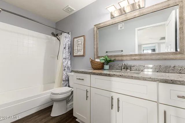 a view of an empty room and a ceiling fan