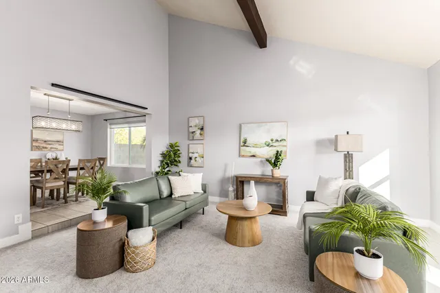 a living room with furniture and a potted plant