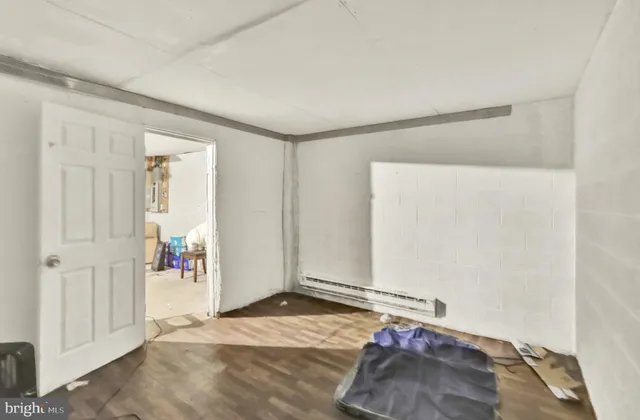 a view of a room with wooden floor