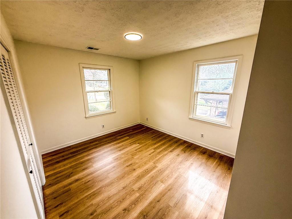 6485 Carolyn Court Rex, GA 30273 - Photo 4 of 12 a view of empty room with wooden floor and fan