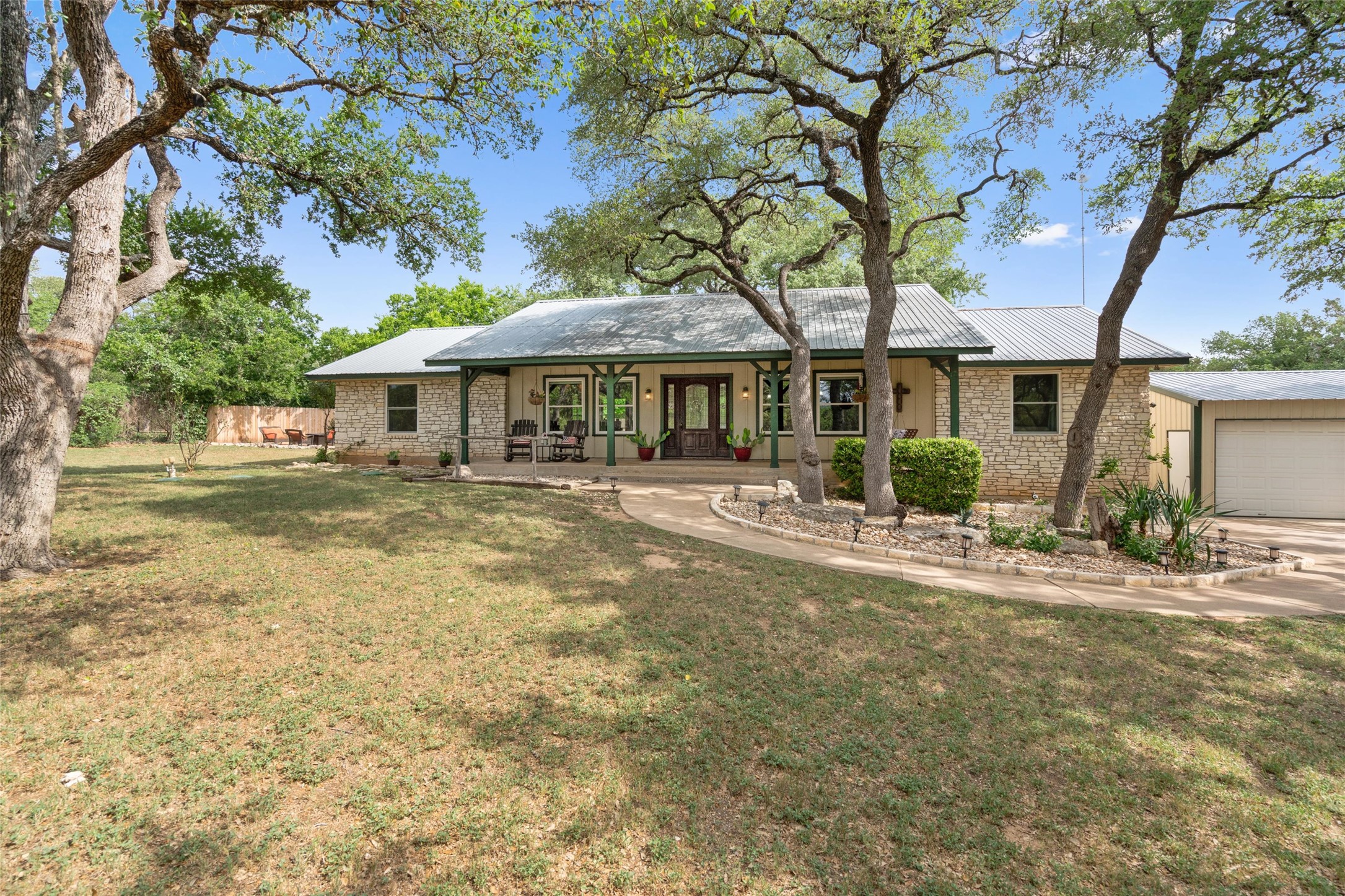 720 Circle G Ranch Road Austin, TX 78737 - Photo 2 of 37 a front view of a house with a garden