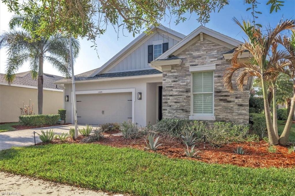 16424 Windsor Way Alva, FL 33920 - Photo 4 of 48 a front view of a house with a garden