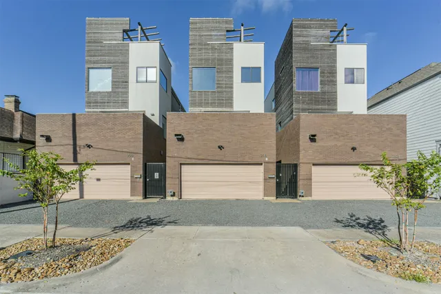 a front view of a building with potted plants