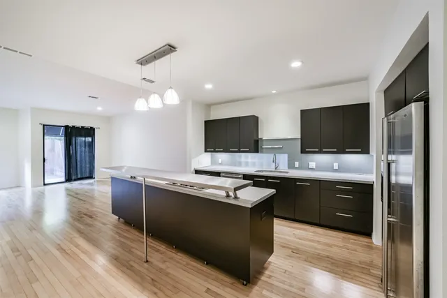a kitchen with stainless steel appliances granite countertop a sink and a stove top oven
