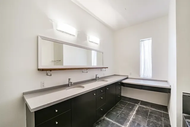 a bathroom with a tub sink and mirror