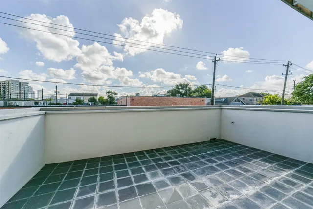 a view of a hallway with a ceiling fan and window